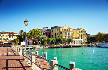 Bridge embankment yacht pier Lake Garda restaurants hotels luxury resort Sirmione Italy - 142168980