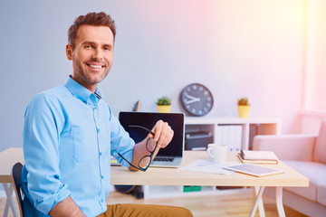 Portrait of happy man working from home office