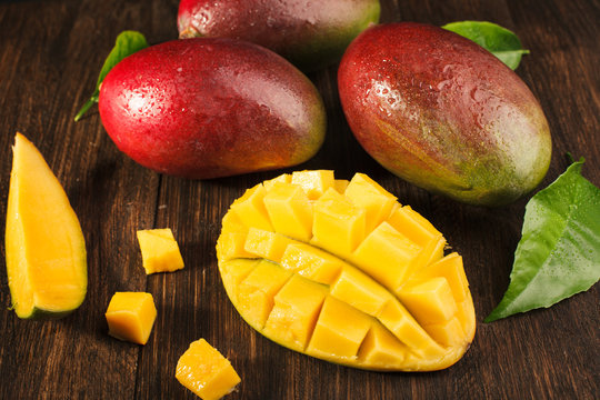 Slised ripe mango on wooded board.