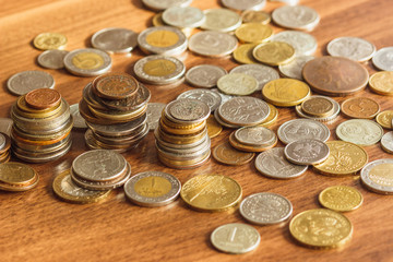 Different gold and silver collector's coins on the wooden table