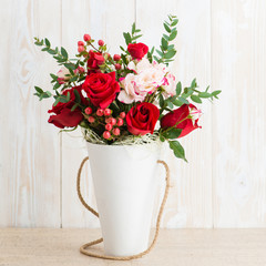 Spring bouquet in a round box on a wooden background. Copyspace