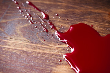 A puddle of blood on a wooden background