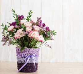 Spring bouquet in a round box on a wooden background. Copyspace