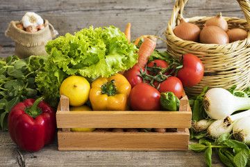 Vegetables in basket on wooden table
