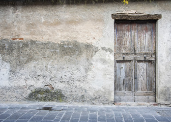 Wooden door in an old Italian house, copy-space.