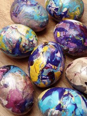 Easter eggs artistically painted blue , purple and gold