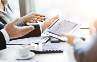 Image of human hand pointing at touchscreen, working environment at meeting