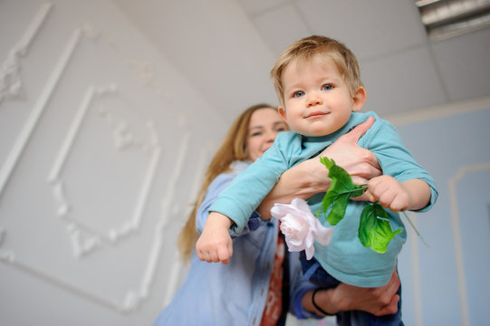 The young woman plays with the little son.
