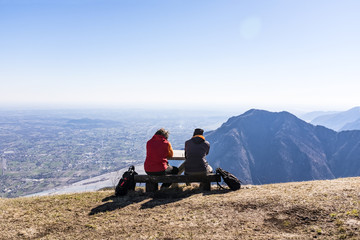 Hikers taking a break with view to Friuli-Venezia Giulia