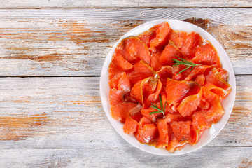 slices of salted red fish on white plate