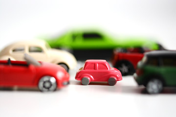 Fototapeta na wymiar Traffic jam concept or advantages of small cars with multiple toy cars on white background