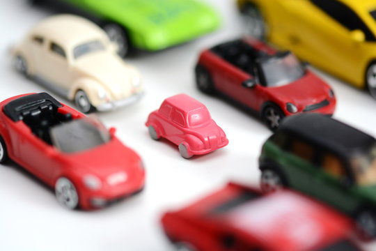 Traffic jam concept or advantages of small cars with multiple toy cars on white background