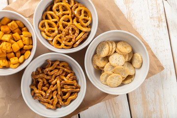 Pretzels in bowls on wooden table from above