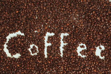 Obraz na płótnie Canvas The words coffee written against scattered natural coffee