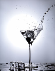 Splash Martini from ice cube in martini glass