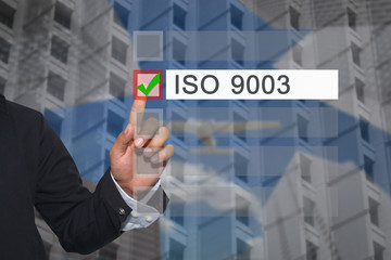 Hand of businessman use finger touch to button to select in Text box of ISO 9003.