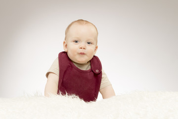 Cute little baby boy with a duck face, lovely baby portrait