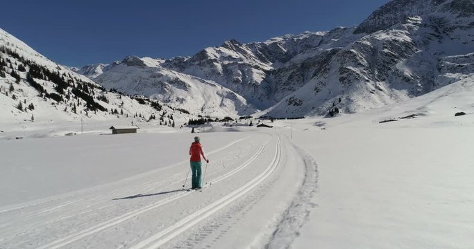 Aerial view of woman skiing on groomed trail