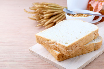 Fototapeta na wymiar slice of bread on wood background