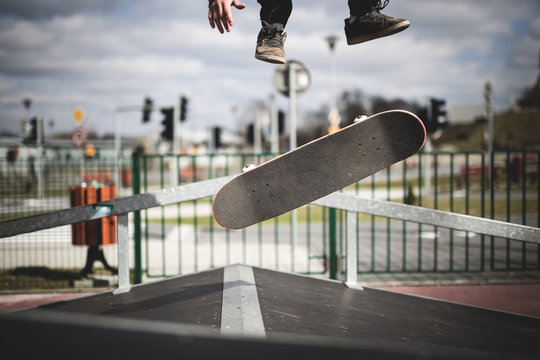 Skater doing a kickflip trick on funbox