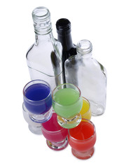 Cocktail in a glass and bottles on white background