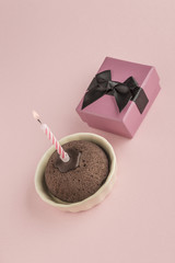 birthday cake and gift box on pink