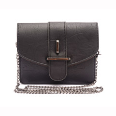 Black leather clutch with chain isolated on white