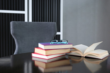 Open book and glasses on wood table. Education background.