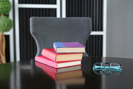 hardback books on wooden table with glasses. Education background.