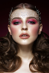 Beautiful girl with perfect art makeup and pearl beads. beauty face. Photos shot in the studio.