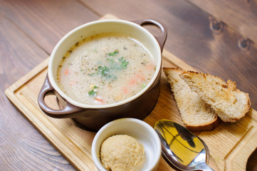 Soup with croutons on the wooden table