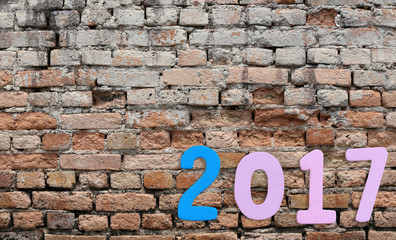 Number of 2017 on a brick wall background.