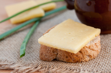 Piece of cheese lies on a close-up bread