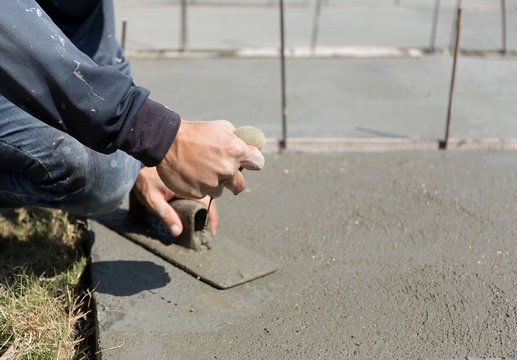 Worker smooth concrete floor squeeze sponge to wet the concrete
