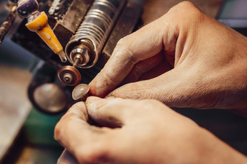 Jewellery polishing a stone blue cubic zirconia