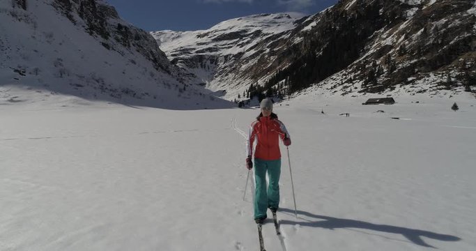 Woman cross-country skiing on fresh snow