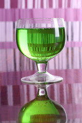Cocktail in a glass on a colored background