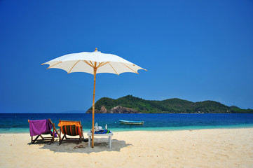 Fototapeta na wymiar White Sand Beach with Beach Umbrella in Summer Season