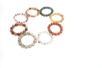 Beautiful translucent assorted colors Rutilated Quartz or Venus’ hairstone bead in bracelets on white background