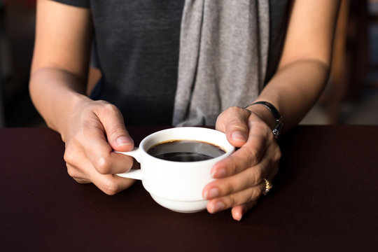 Woman hands holding hot coffee cup
