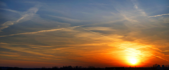 Naklejka na ściany i meble Bright colorful sunset with clouds on the horizon