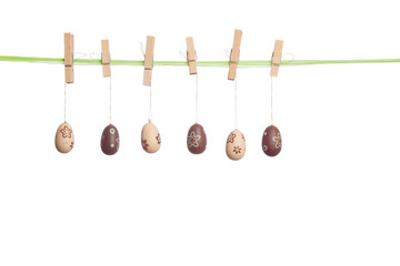 Hanging Easter Eggs on a String, with Clothing Pegs, isolated on white background