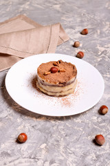 Chocolate mini cake on a plate with nuts