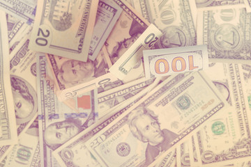 Background from scattered dollar banknotes. Toned.