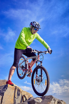 A cyclist who travels in the mountains in summer on a sunny day