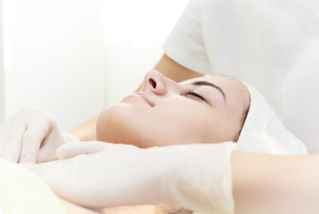 Fototapeta na wymiar Relaxing facial massage.Beautiful young woman receiving facial massage at spa