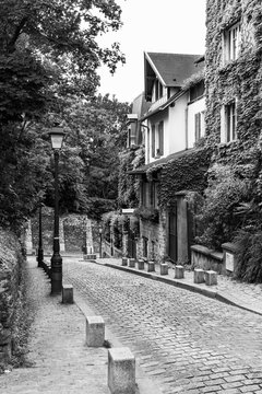 Charming old street of the Montmartre hill in black and white. Paris, France