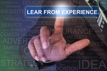 Fototapeta na wymiar Businessman touching LEAR FROM EXPERIENCE button on virtual screen