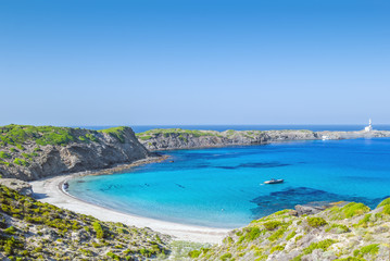 Fototapeta na wymiar Cala Presili beach on a sunny summer day, Menorca