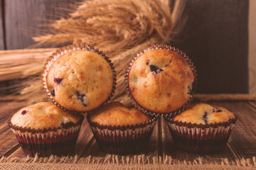 Muffins on wooden background on rustic style. Cupcake with currant